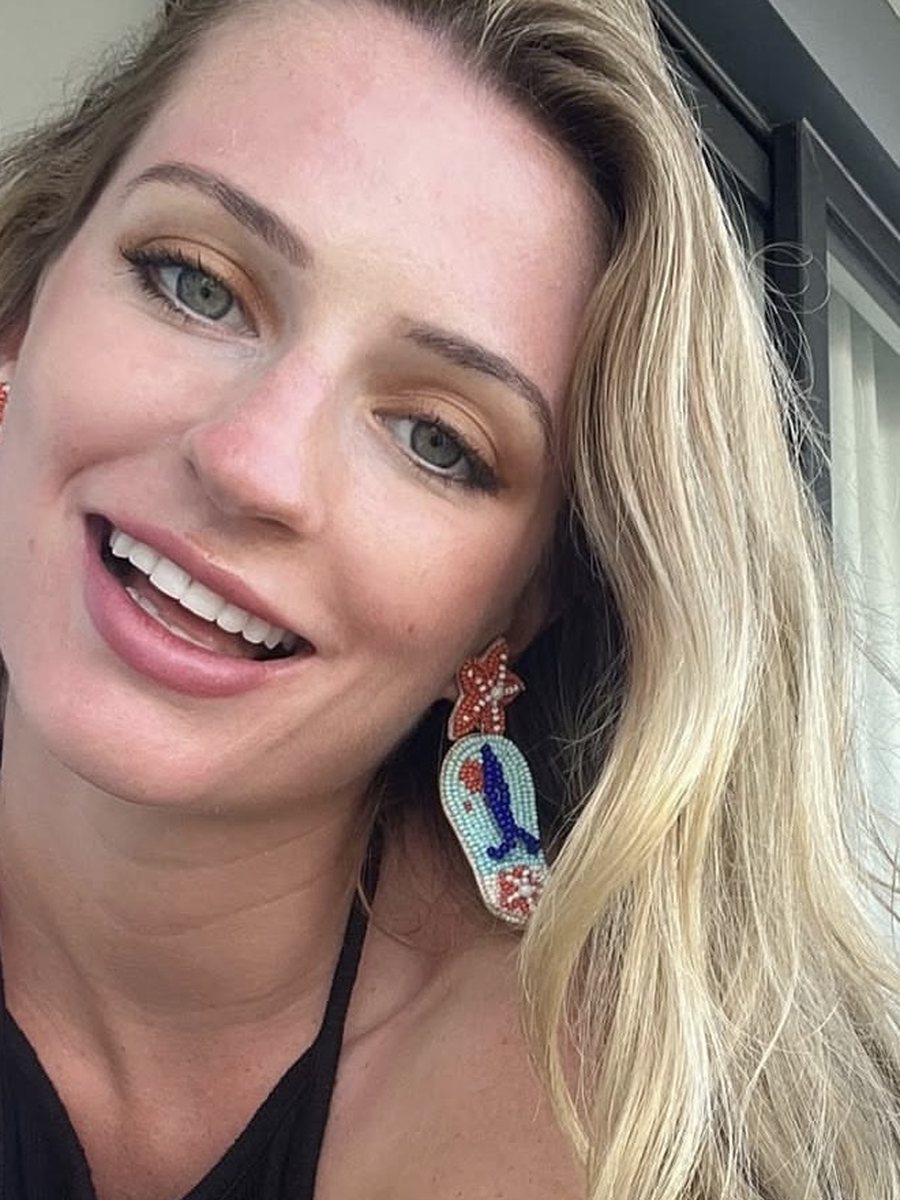 Lily smiling, wearing beaded flip-flop earrings